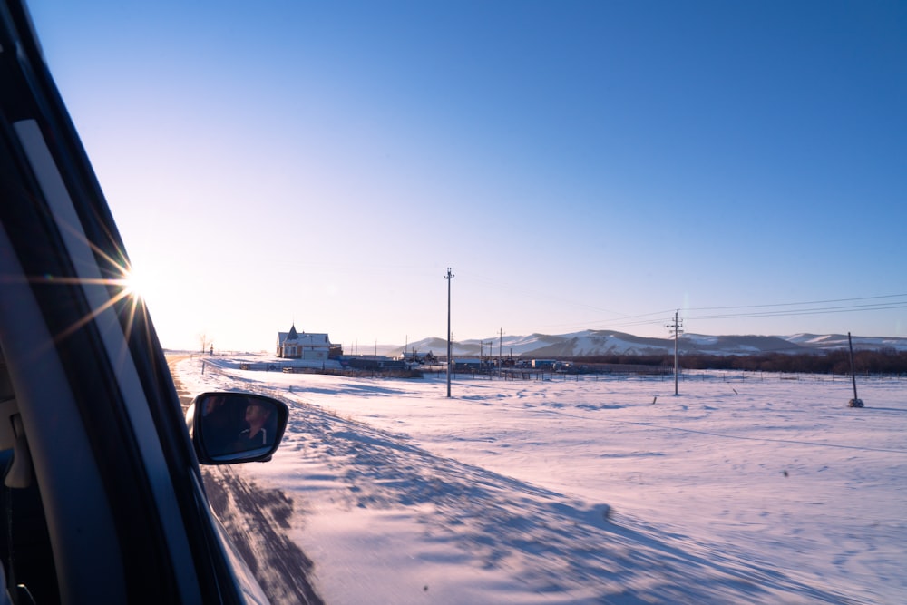 car on snow covered field during daytime