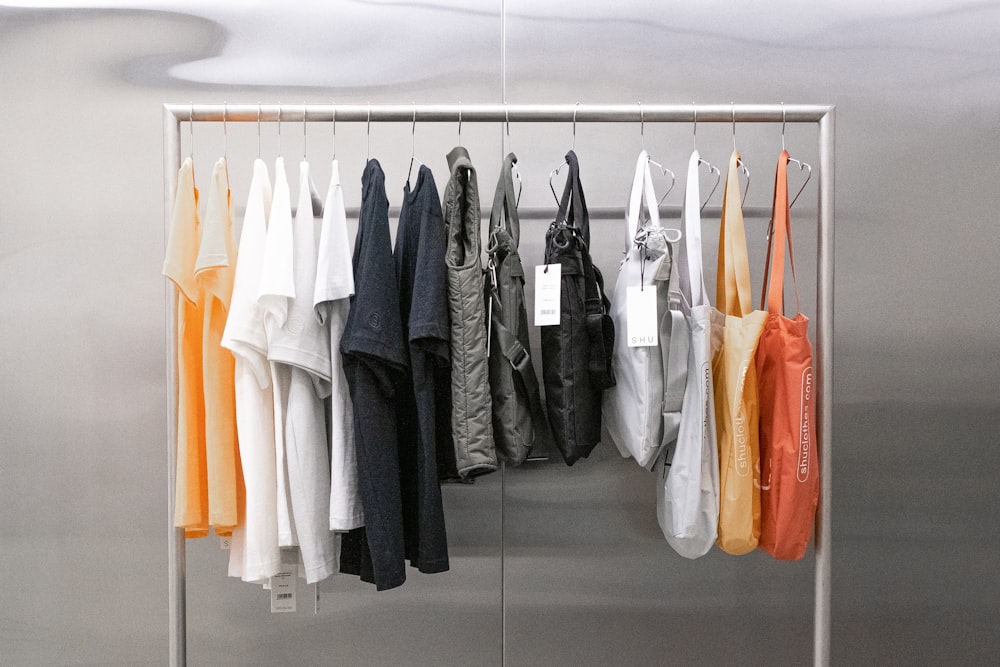 white and orange clothes hanging on white wooden cabinet