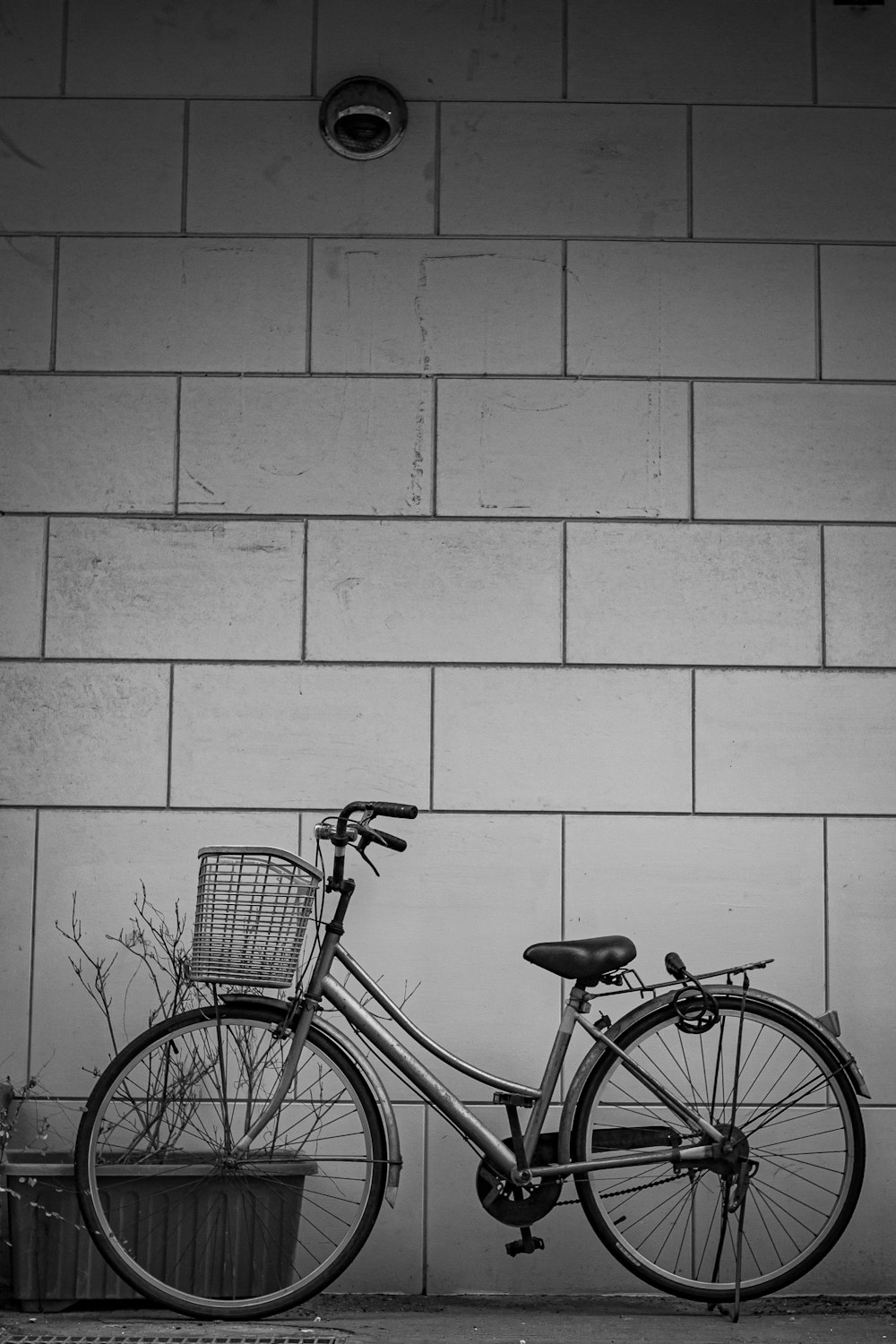 black city bike on gray brick wall