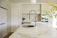 A modern kitchen countertop made from sleek quartz stone with bright natural light.