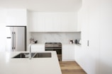 white wooden kitchen cabinet over white kitchen counter