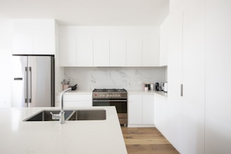 white wooden kitchen cabinet over white kitchen counter