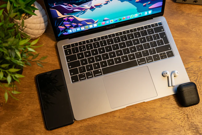 macbook pro on brown wooden table
