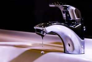 stainless steel faucet on white ceramic sink