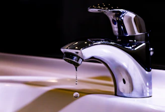 stainless steel faucet on white ceramic sink