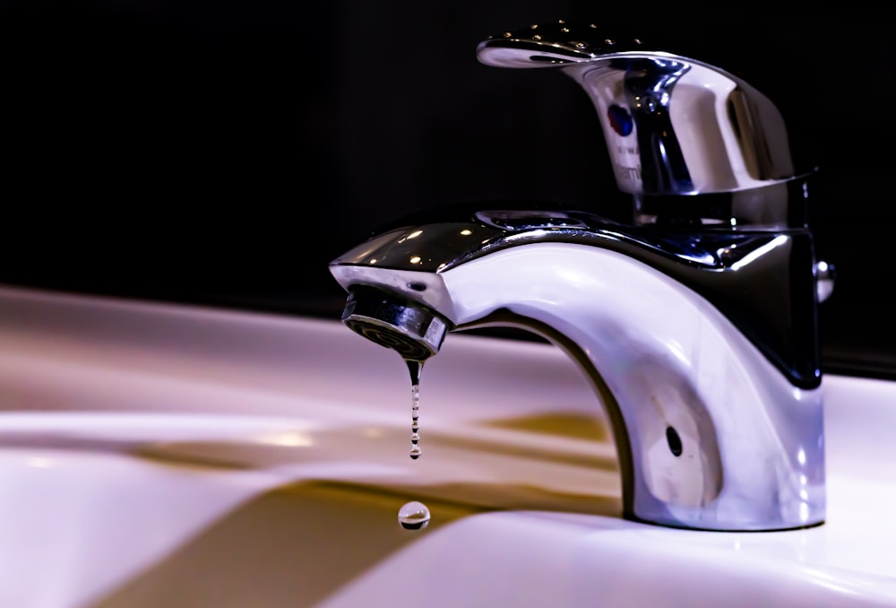 stainless steel faucet on white ceramic sink