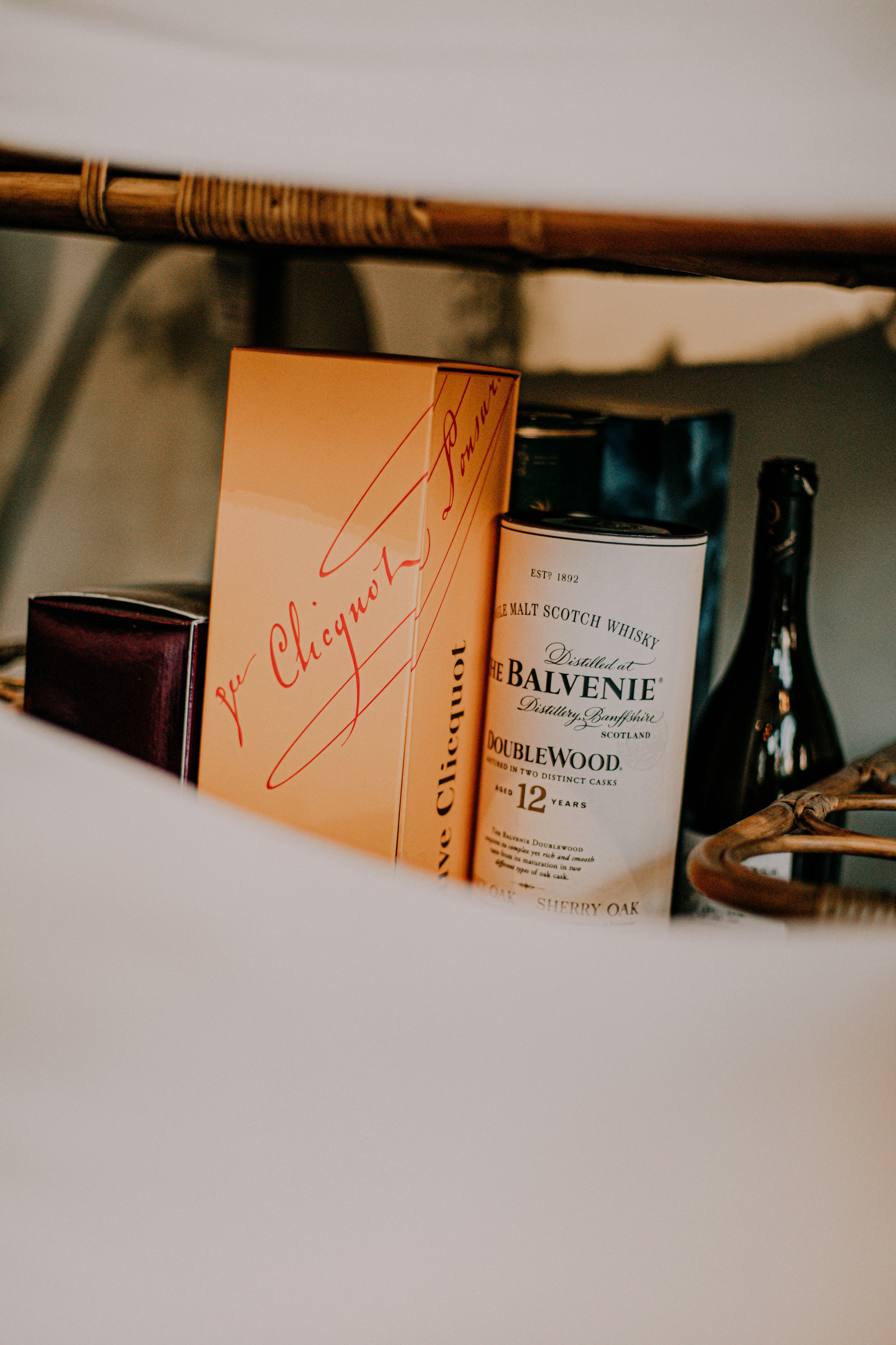 a bottle of wine and some books on a bed