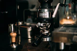 A home coffee setup featuring a grinder, espresso machine, and neatly arranged mugs ready for the day.
