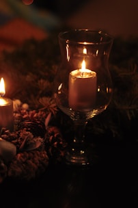 A cozy candle lit in a serene setting, showcasing its warm glow.
