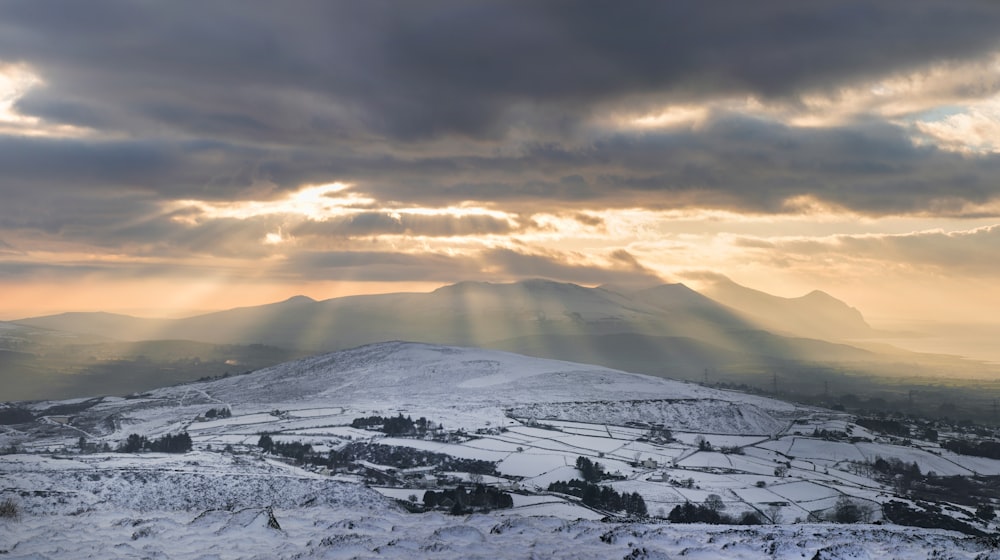 snow covered mountain during sunset