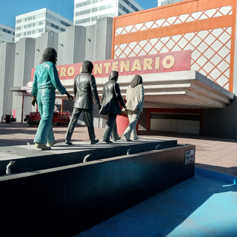 man and woman walking on black skateboard during daytime