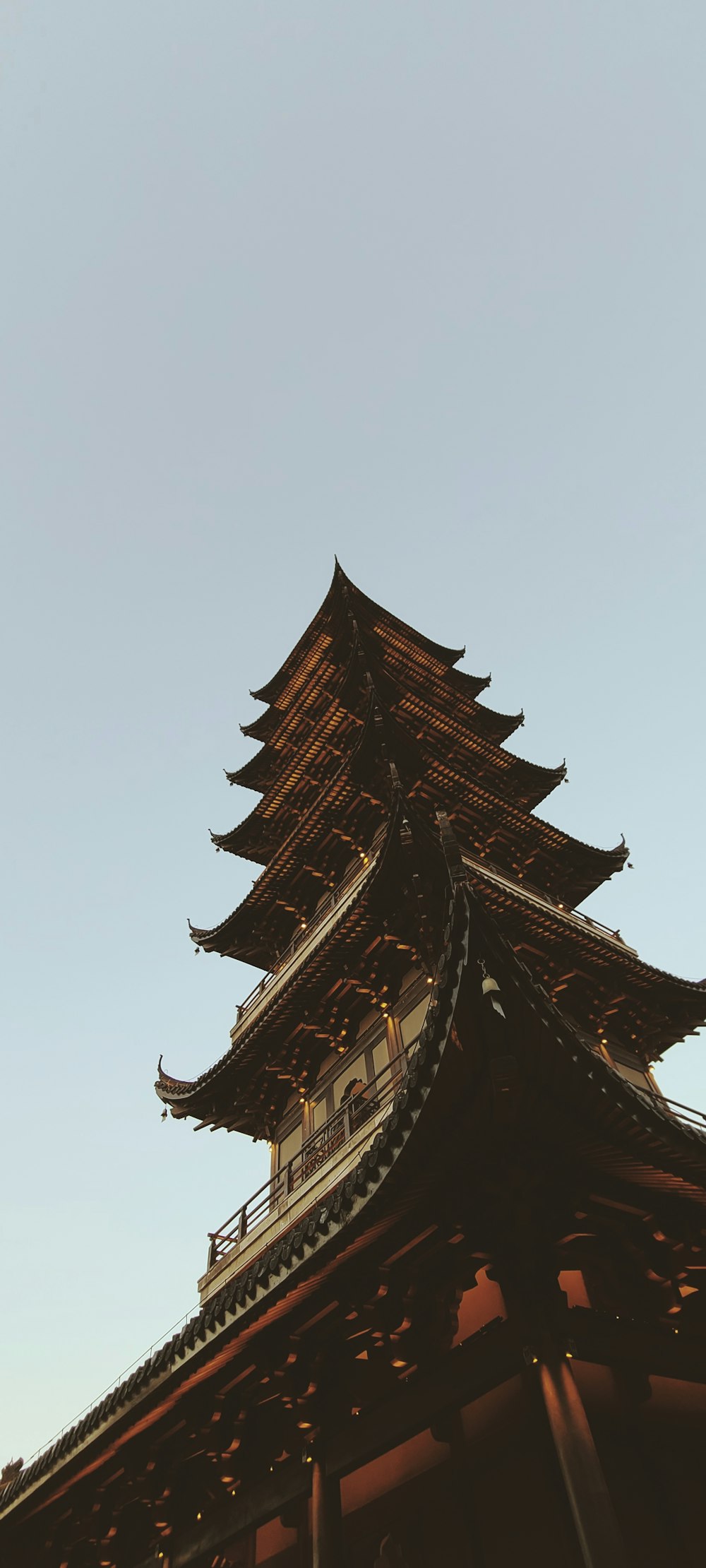 brown wooden pagoda temple under white sky during daytime