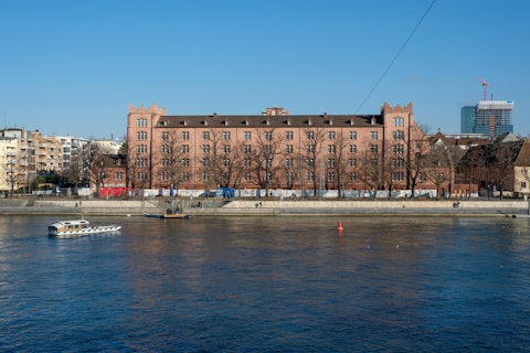 brown concrete building near body of water during daytime
