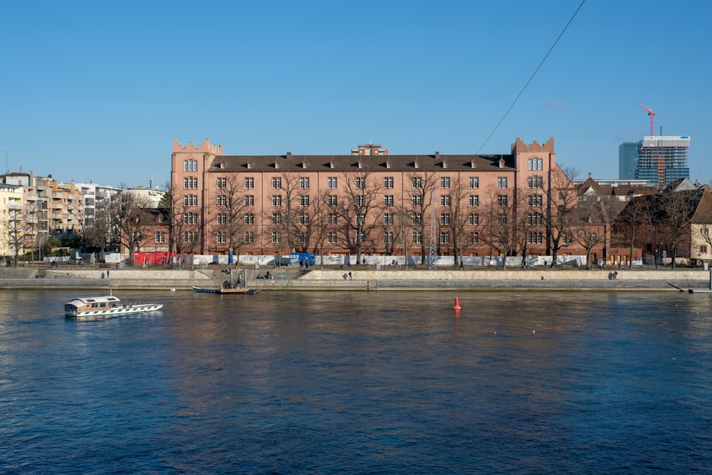 brown concrete building near body of water during daytime