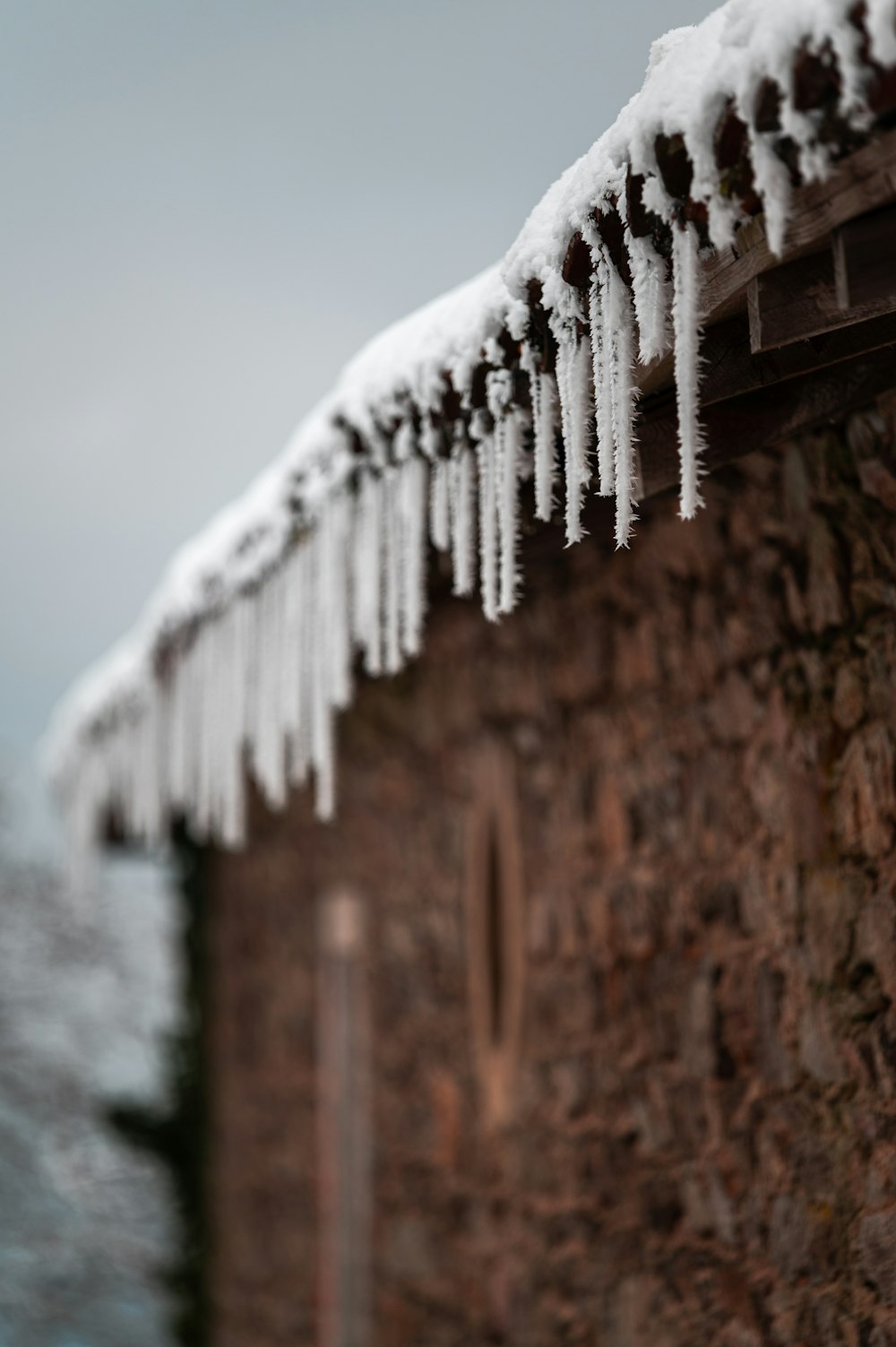 snow covered brown brick wall