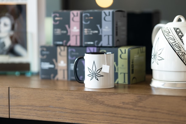 A beautifully arranged personalized box with tea and coffee decor on a wooden table.