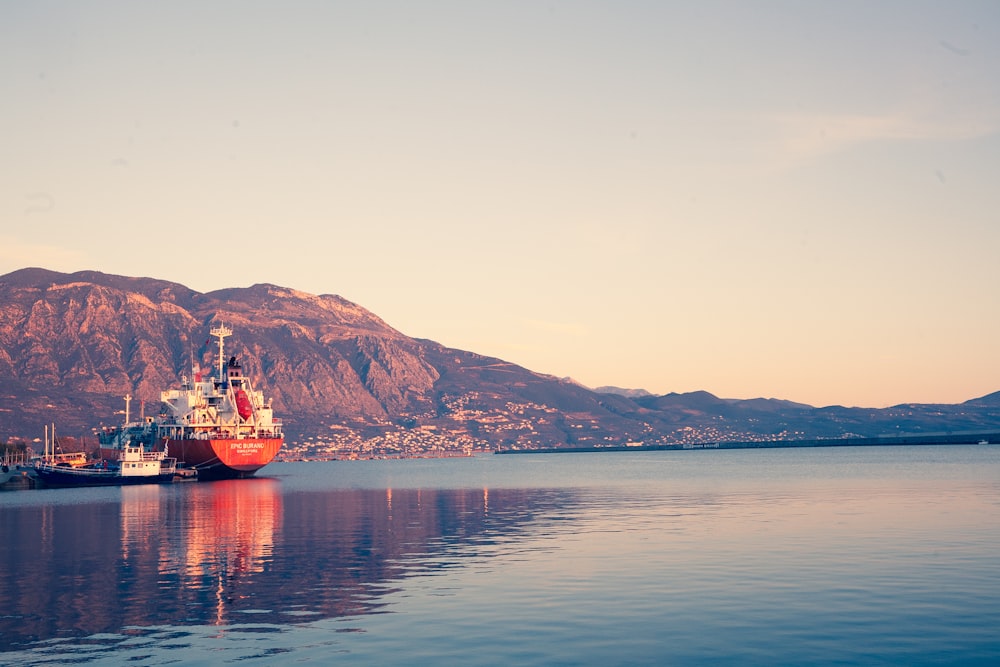 red and white boat on sea during daytime