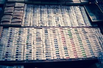 Stacked storage boxes in various sizes and colors neatly arranged in a closet.