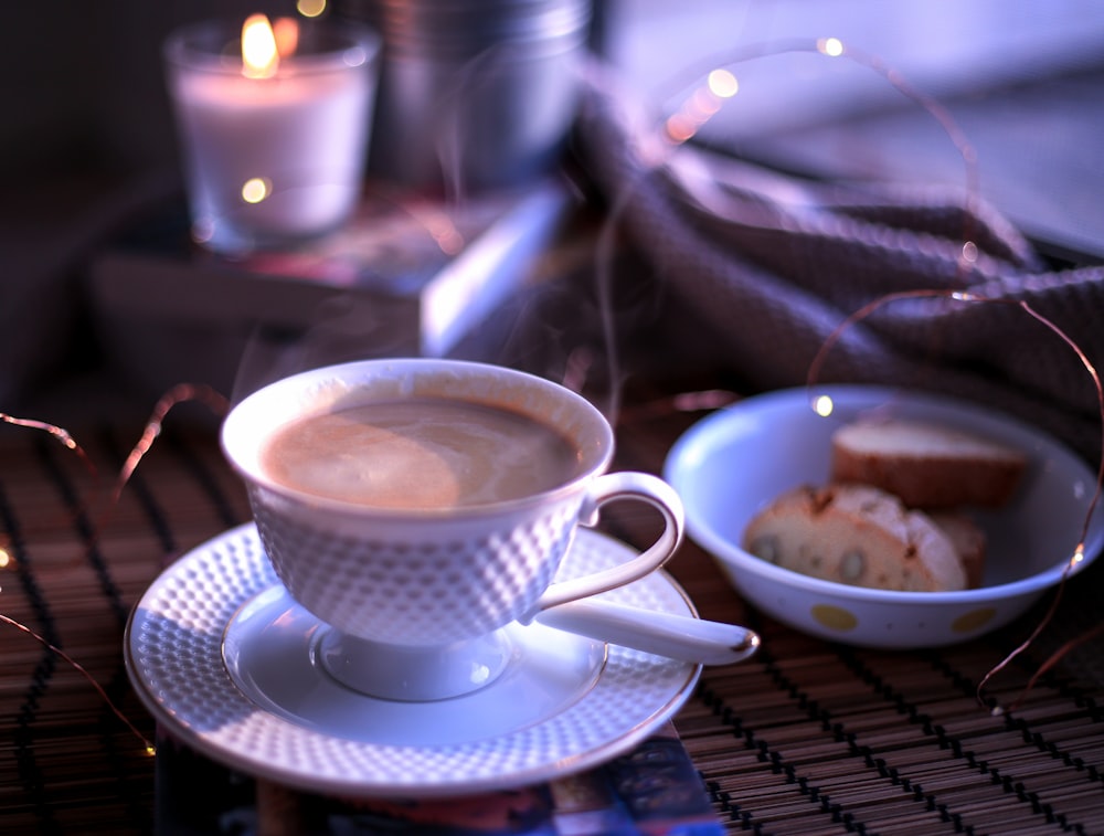 white ceramic teacup on blue saucer