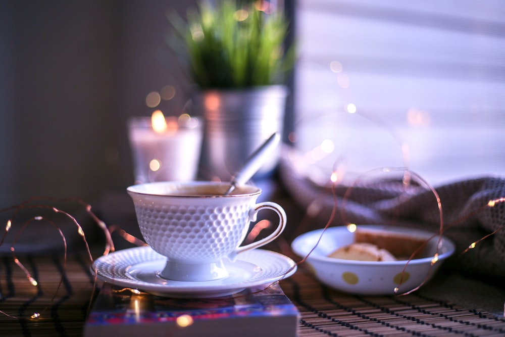 white ceramic teacup on saucer