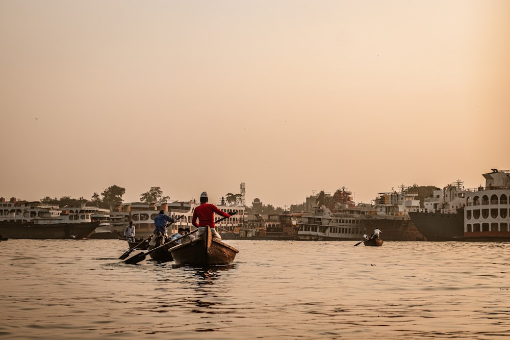 man in red shirt riding on boat during daytime