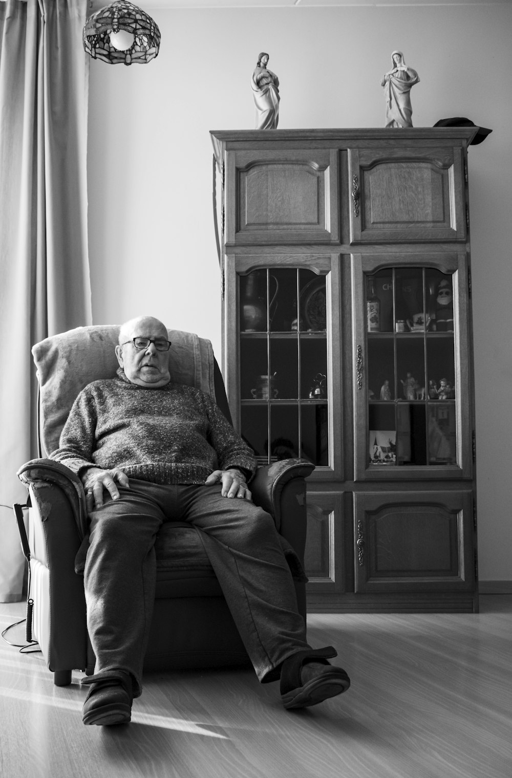 man in sweater sitting on chair