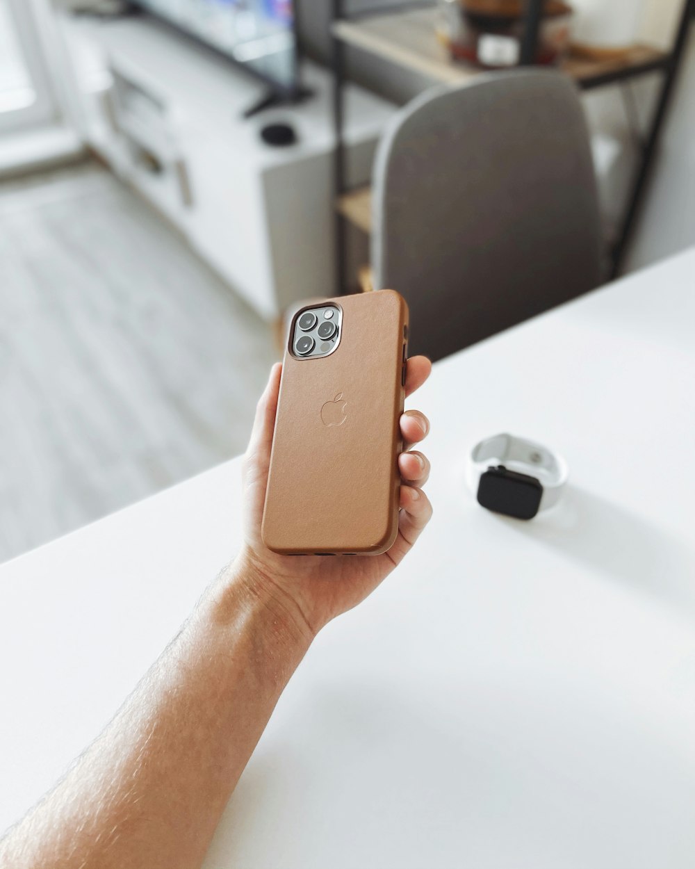 person holding brown iphone case