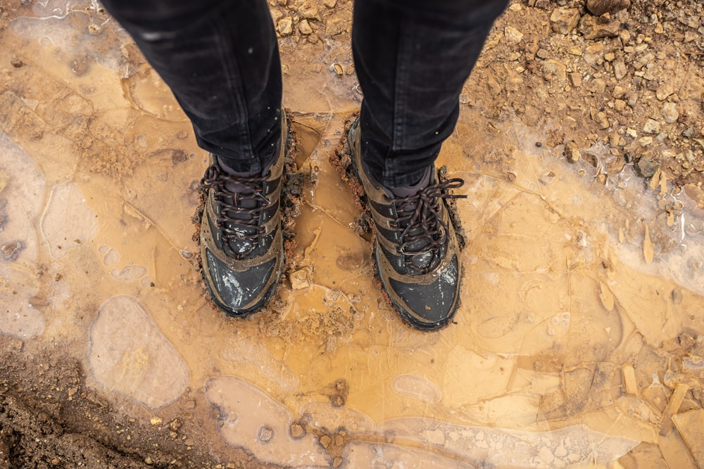 person in black pants and black hiking shoes