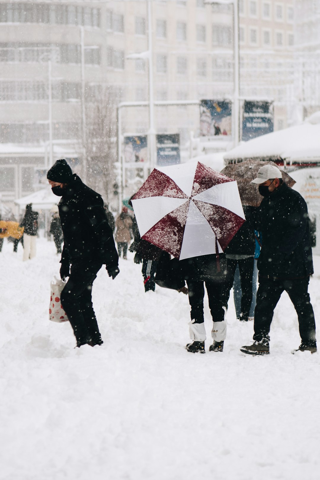 people walking on snow covered field during daytime