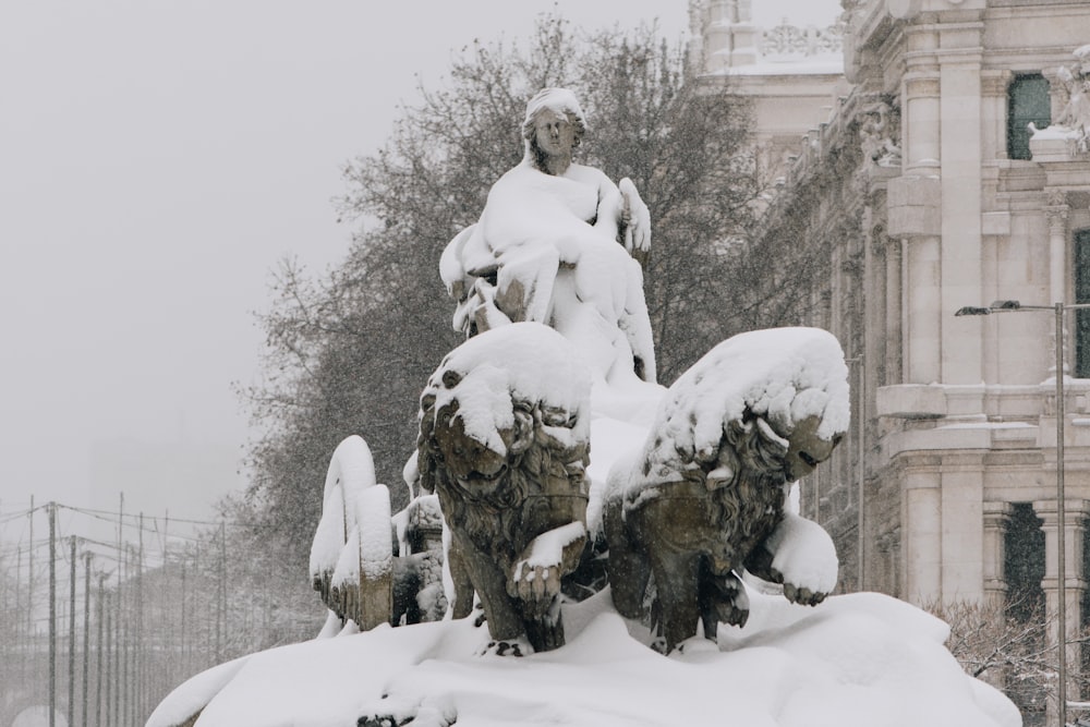 man and woman statue covered with snow