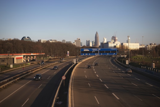A confident driver navigating a busy city street with clear traffic signs.