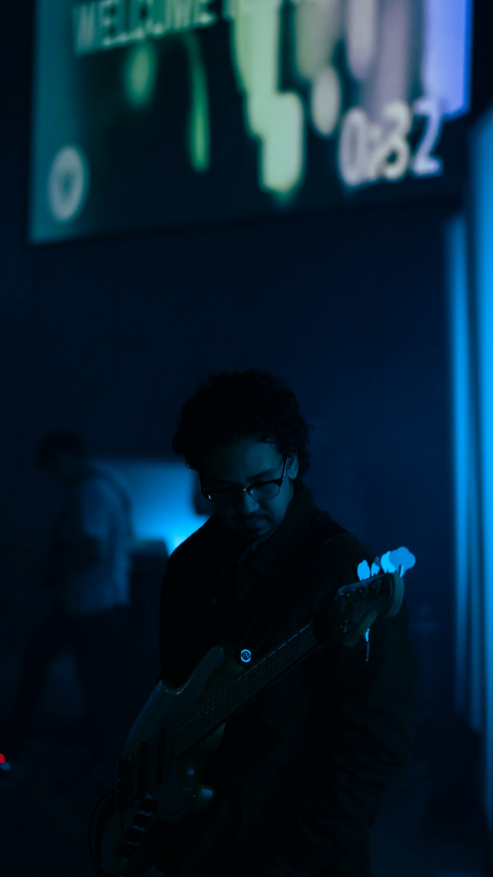 man in black suit holding microphone