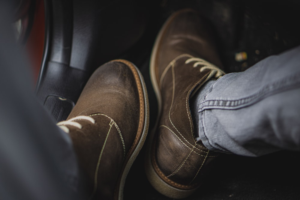 person wearing brown leather shoes