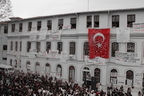 people in front of white concrete building during daytime