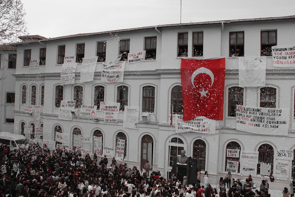 people in front of white concrete building during daytime