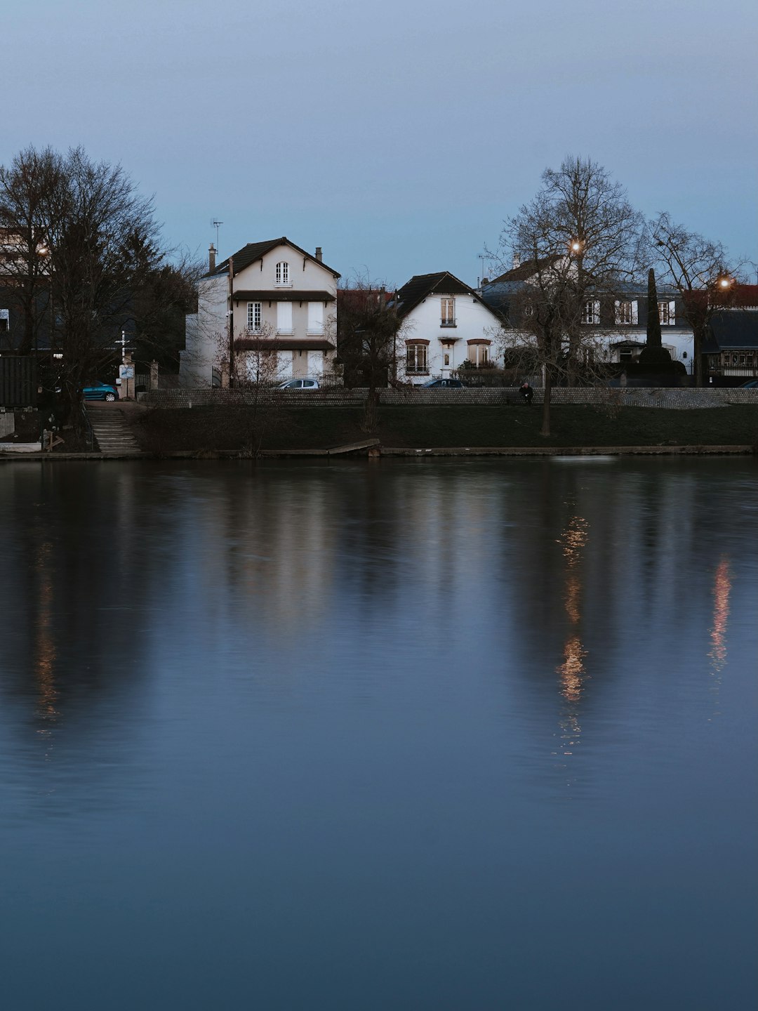 white and brown house near body of water during daytime