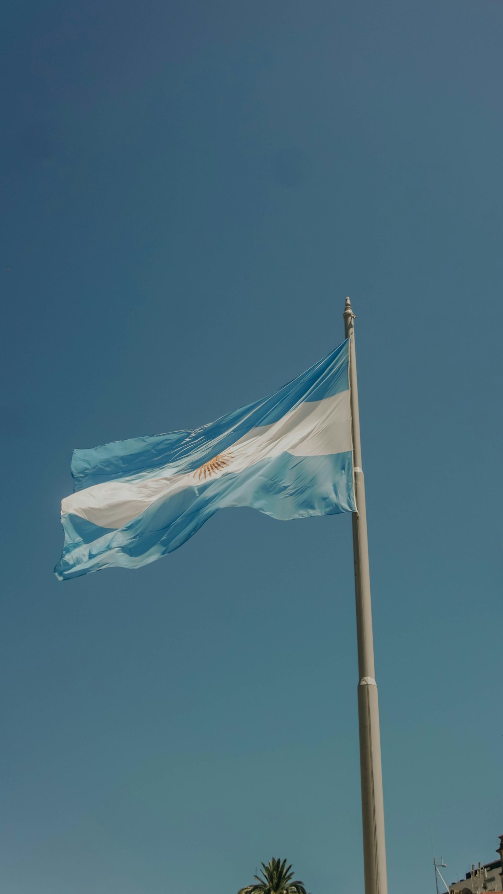 blue and white flag under blue sky during daytime