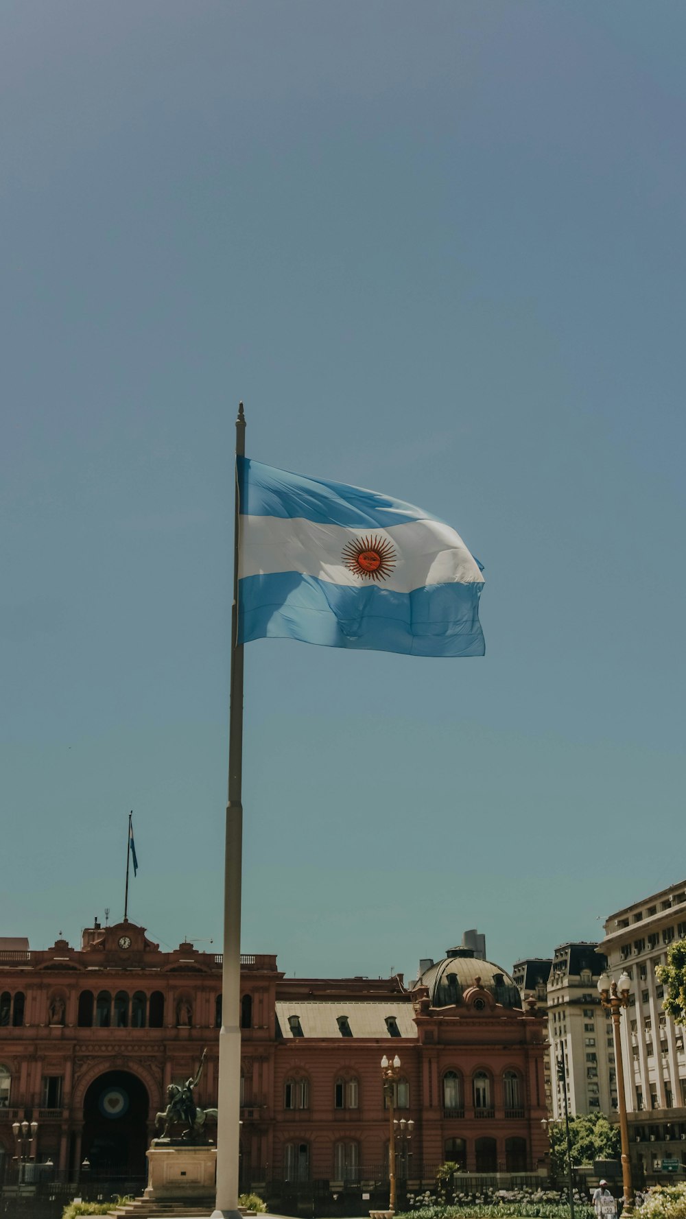 white and blue flag on pole during daytime