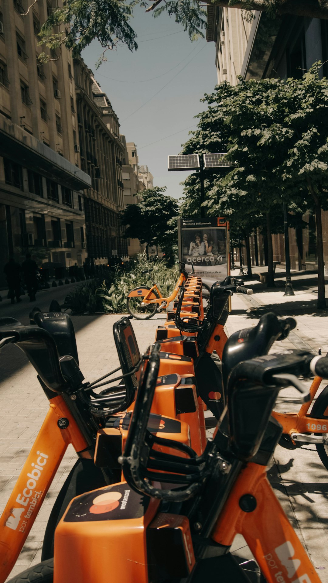 black and orange motorcycle parked on sidewalk during daytime