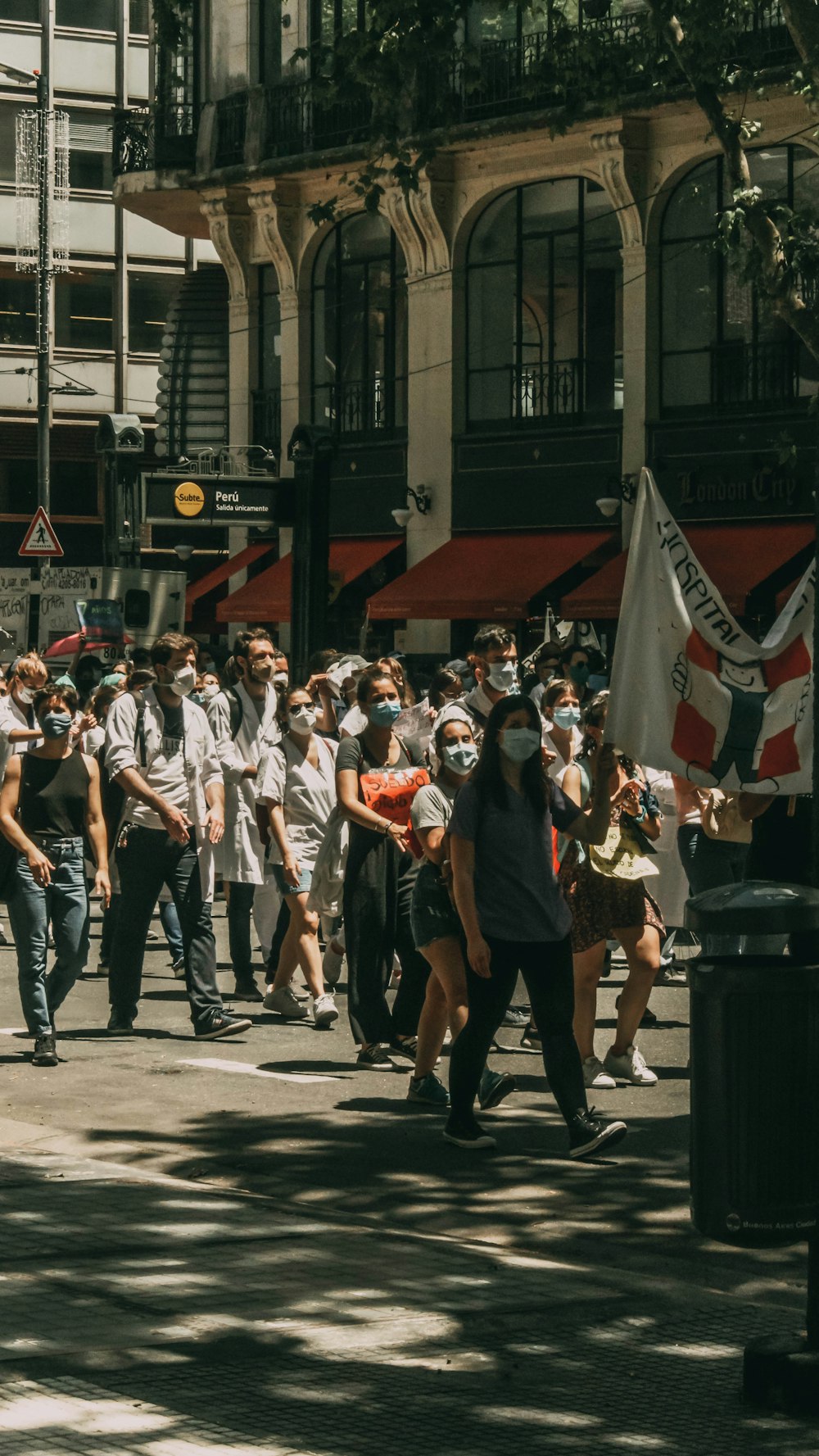 groupe de personnes debout sur le sol en béton gris pendant la journée