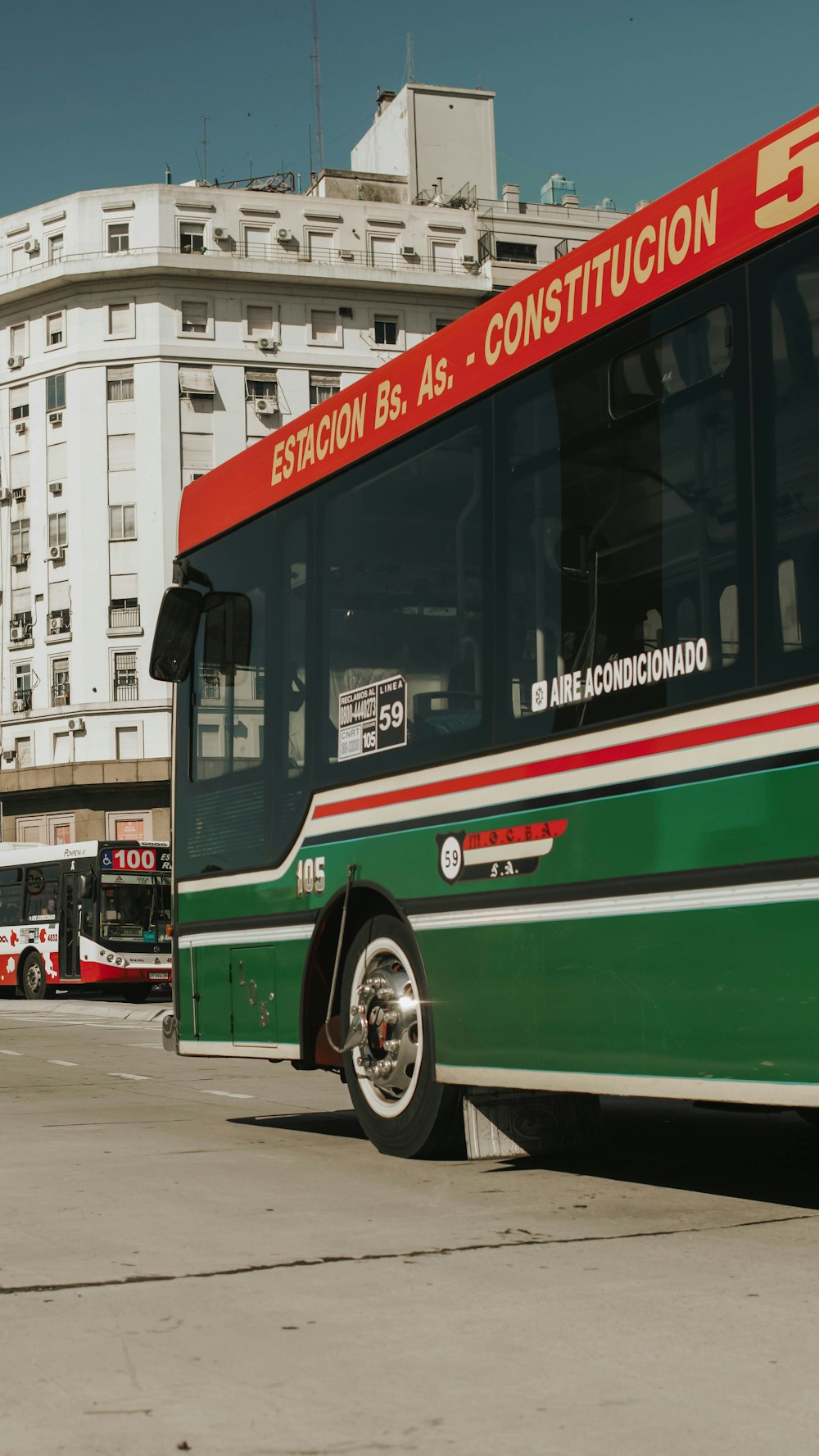 red and green bus on road during daytime