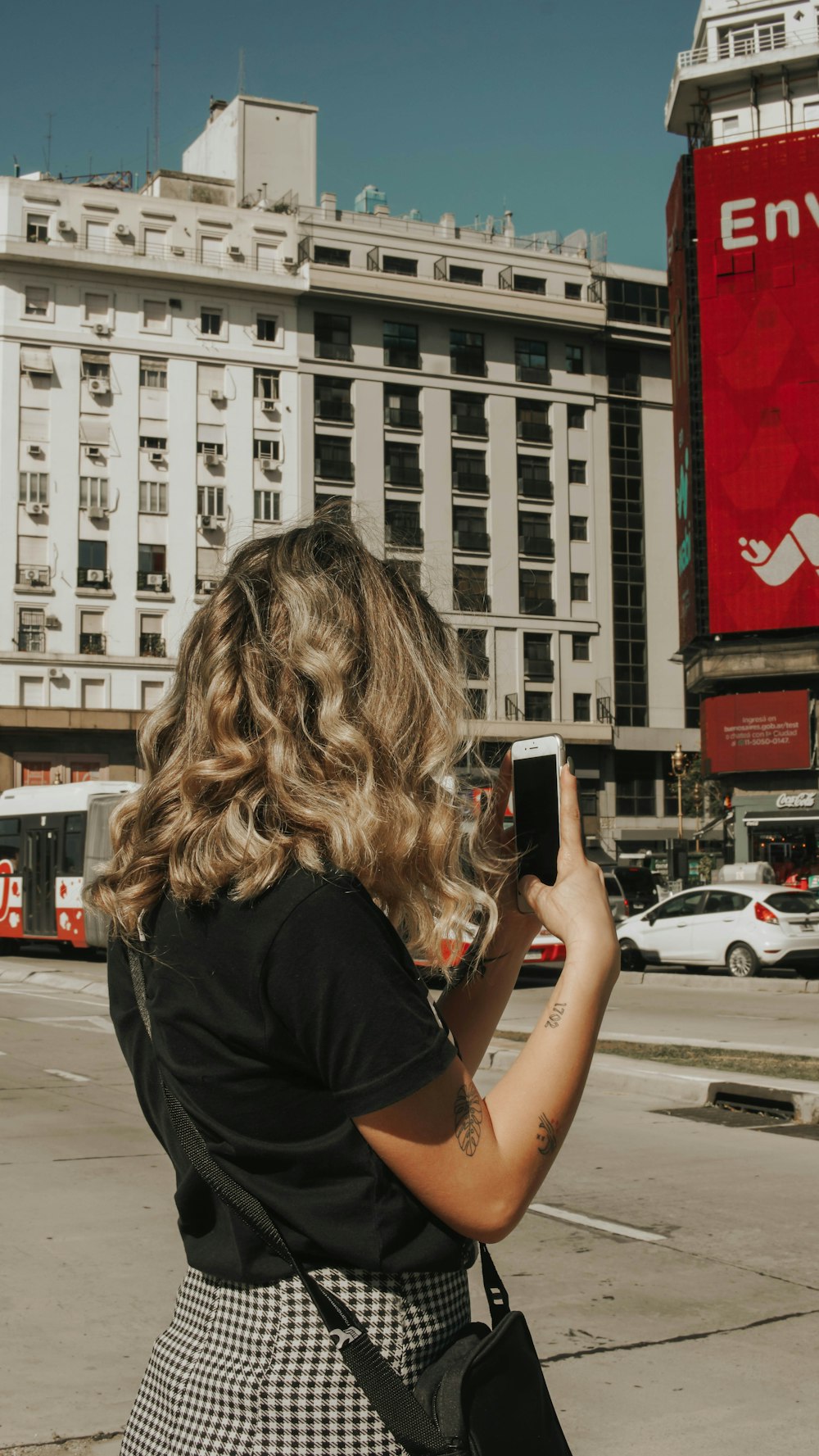 woman in black t-shirt holding smartphone