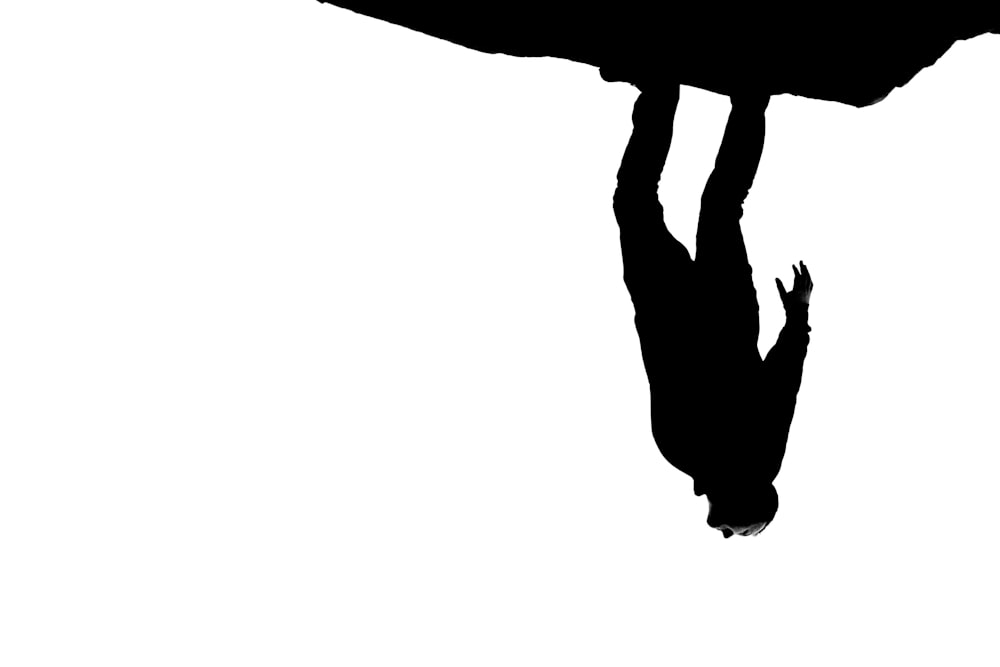 silhouette of person jumping on mid air