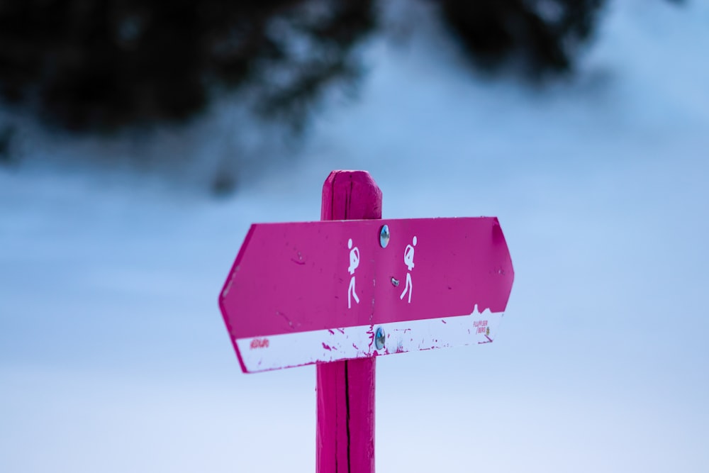 red and white wooden arrow sign