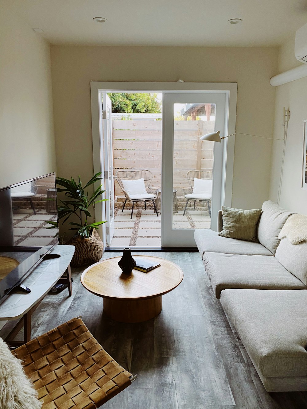 brown wooden round table near white couch