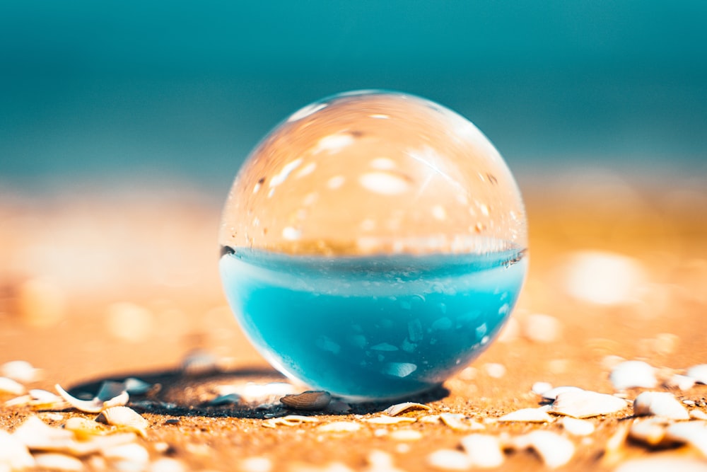 clear glass ball on brown sand