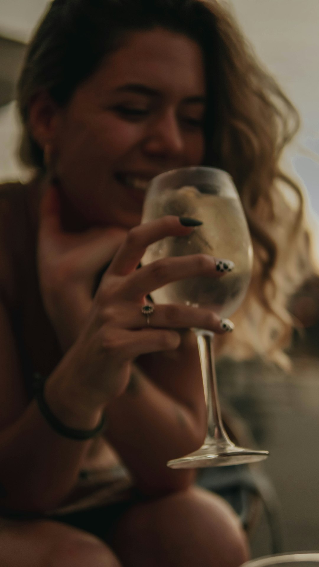 woman in black tank top holding silver spoon