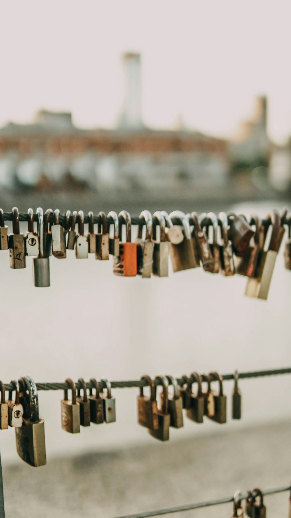 brown padlock on black metal fence