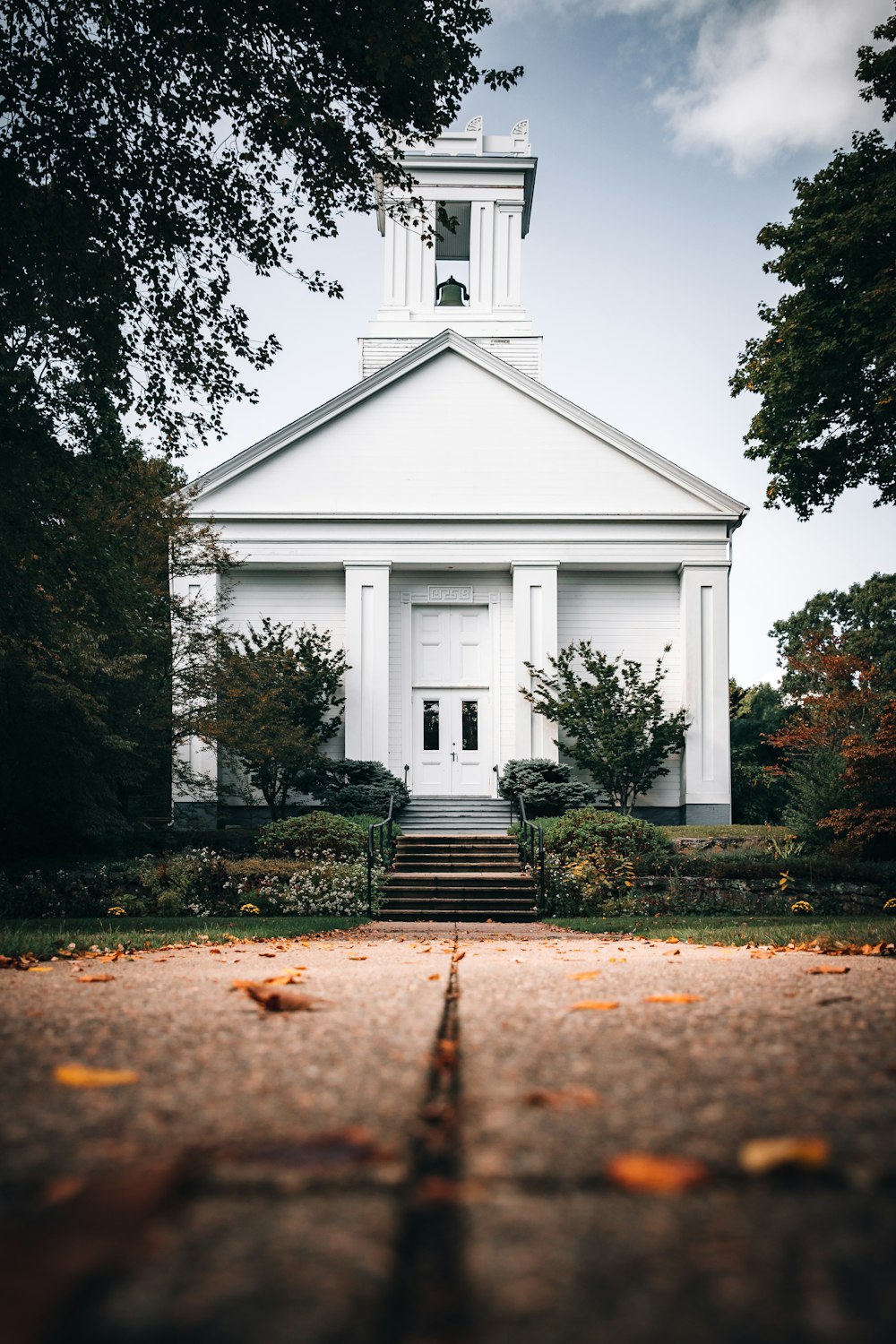 white and black church near green trees during daytime