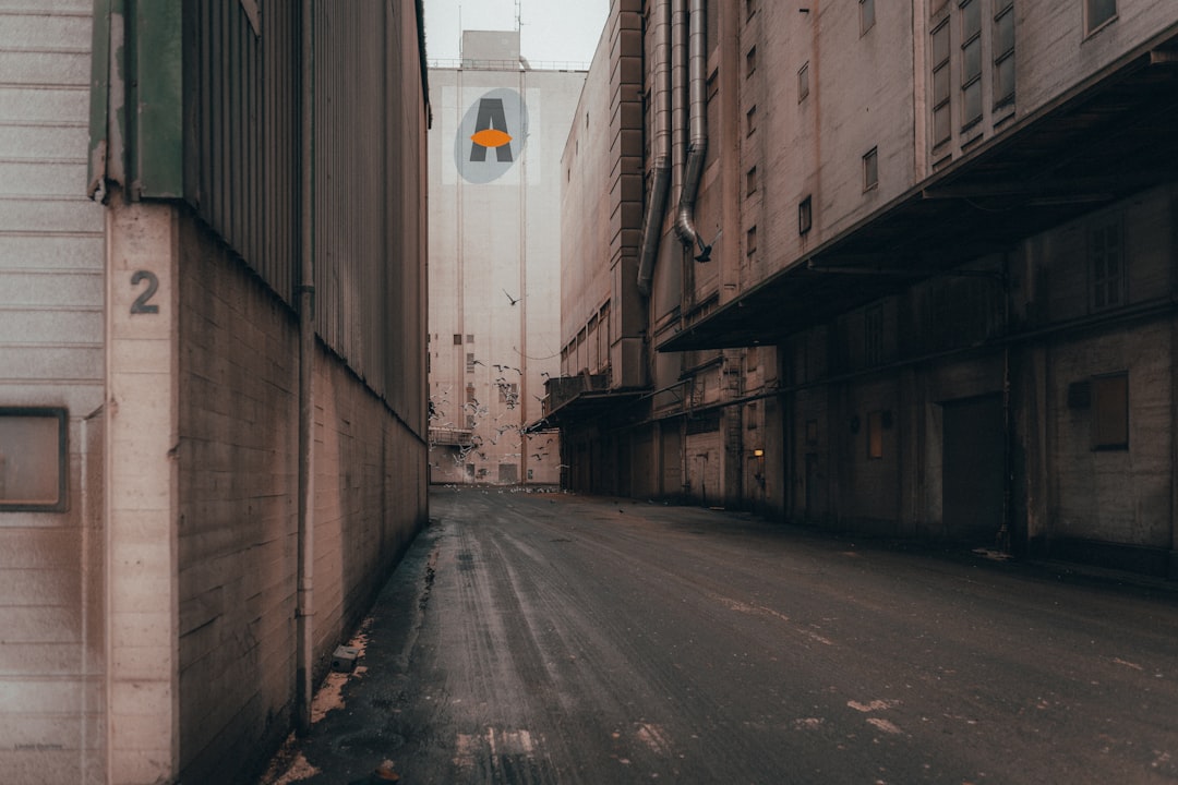 empty road between concrete buildings during daytime